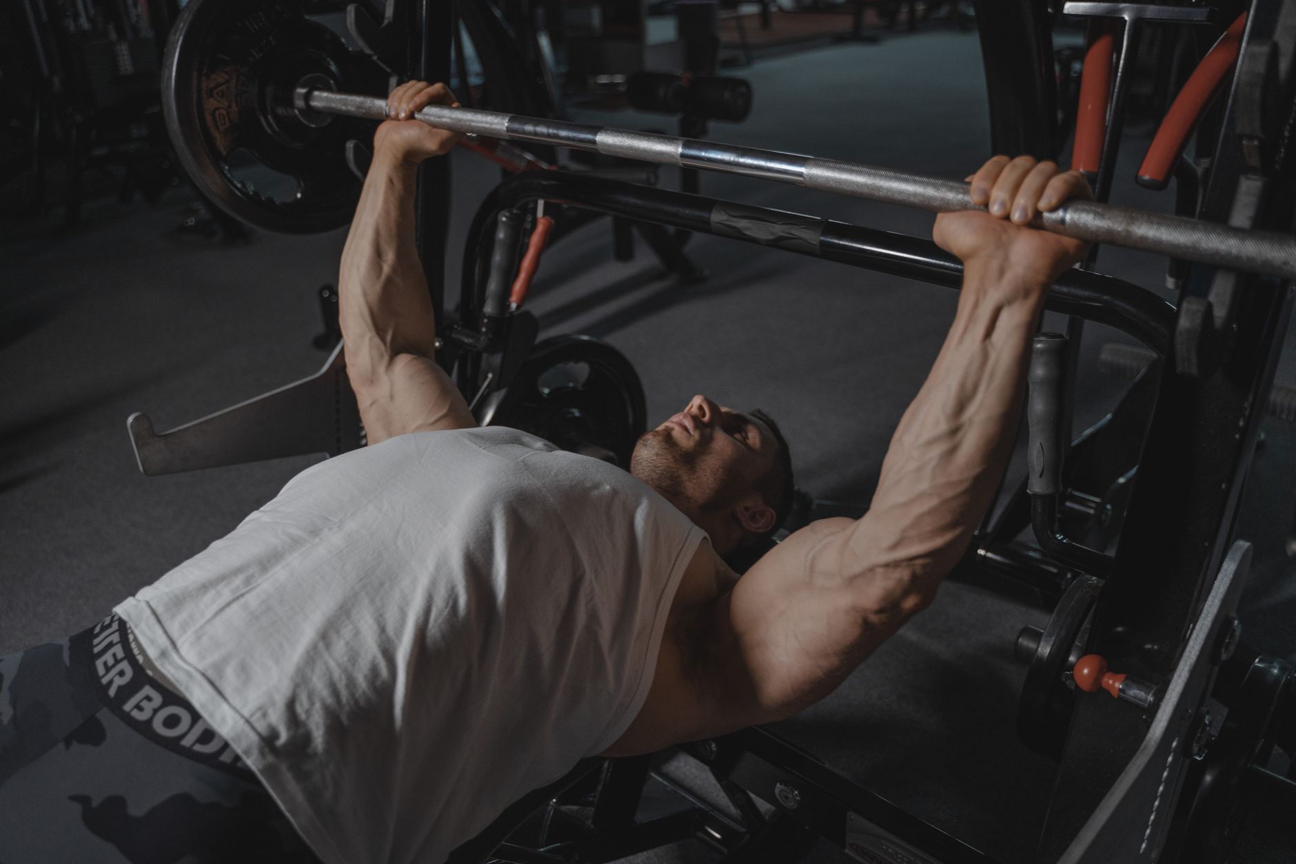 A man performing a bench press with heavy weight