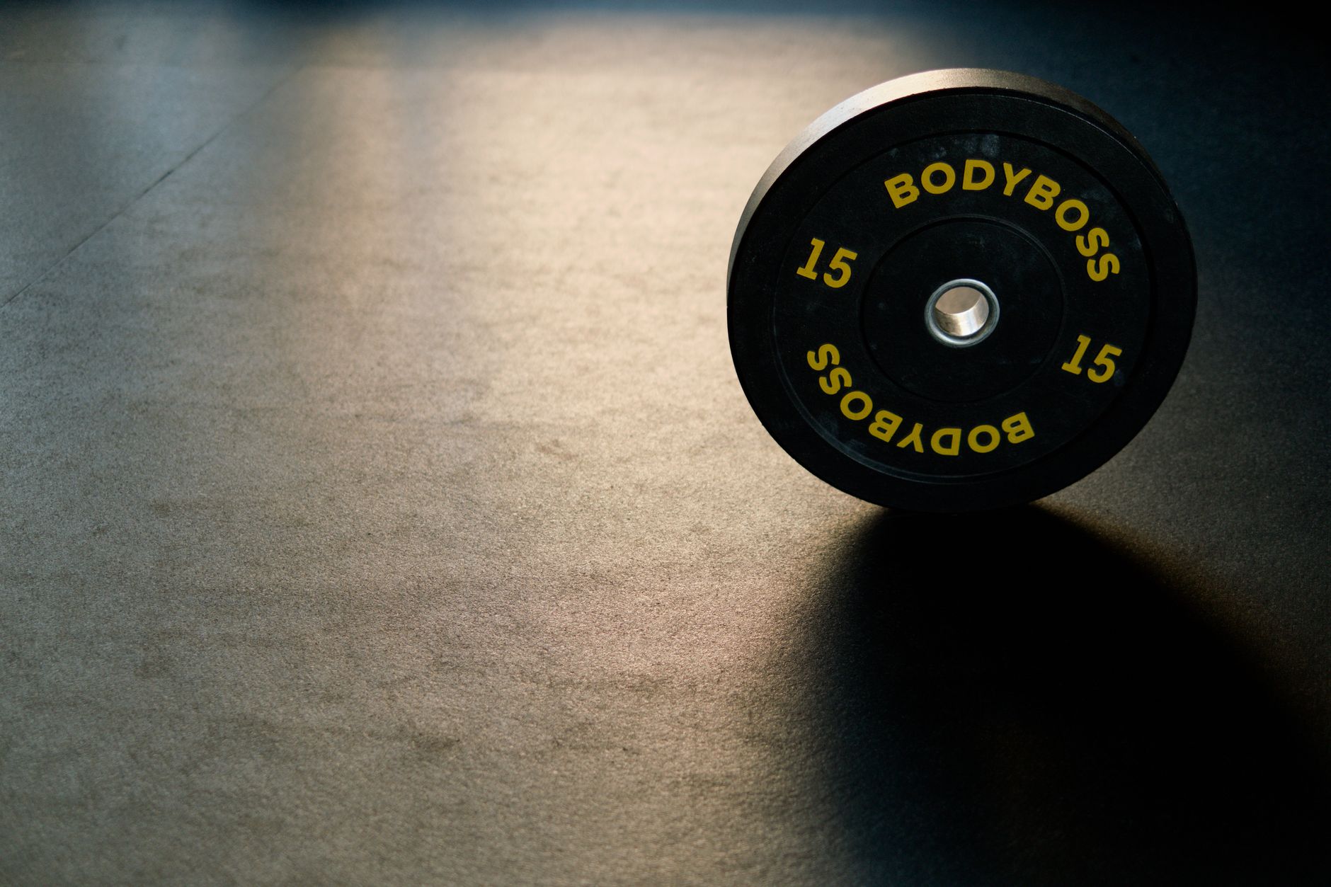 Lifter performing a bench press on the floor with a barbell