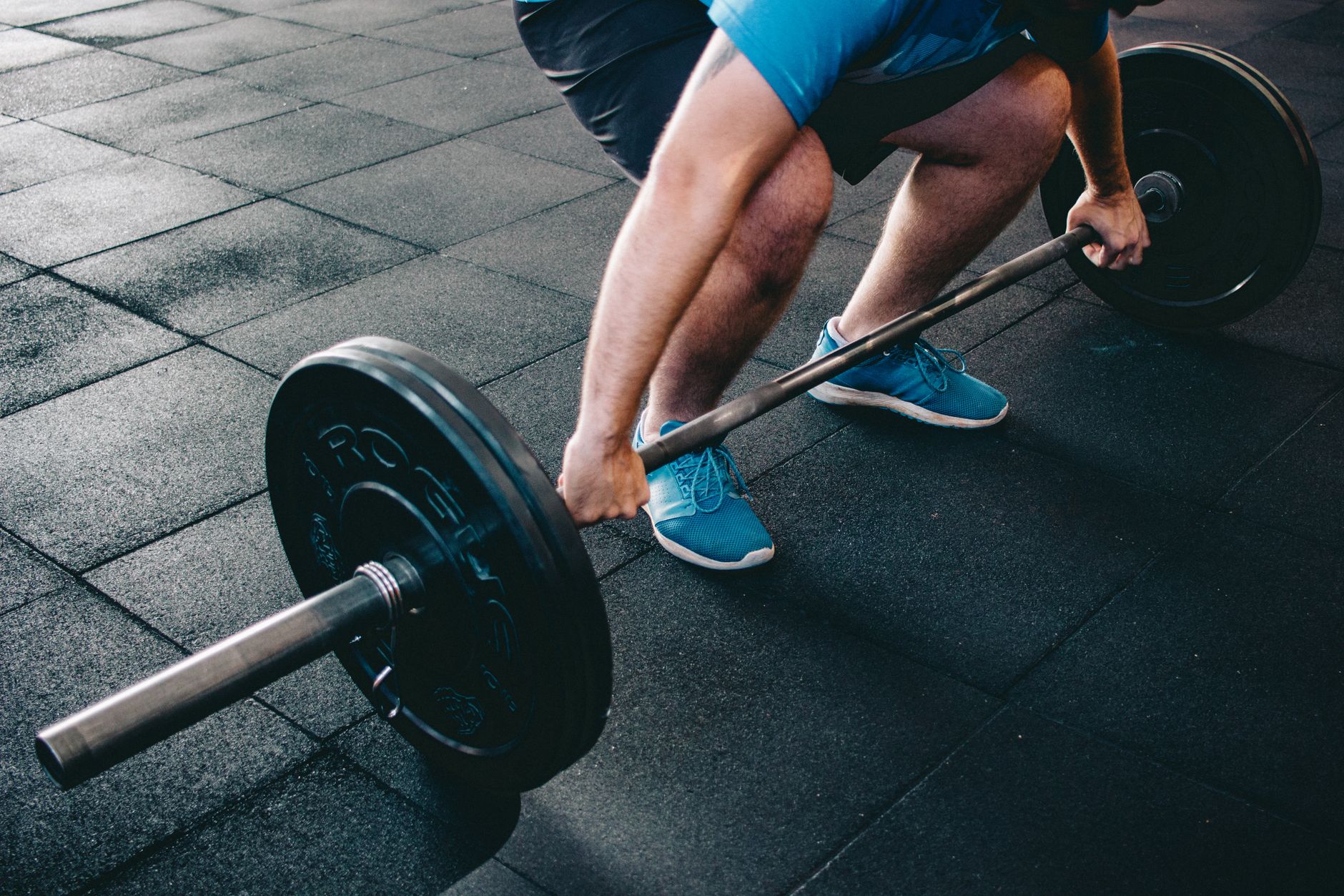 A weightlifter holding a heavy barbell, looking determined.