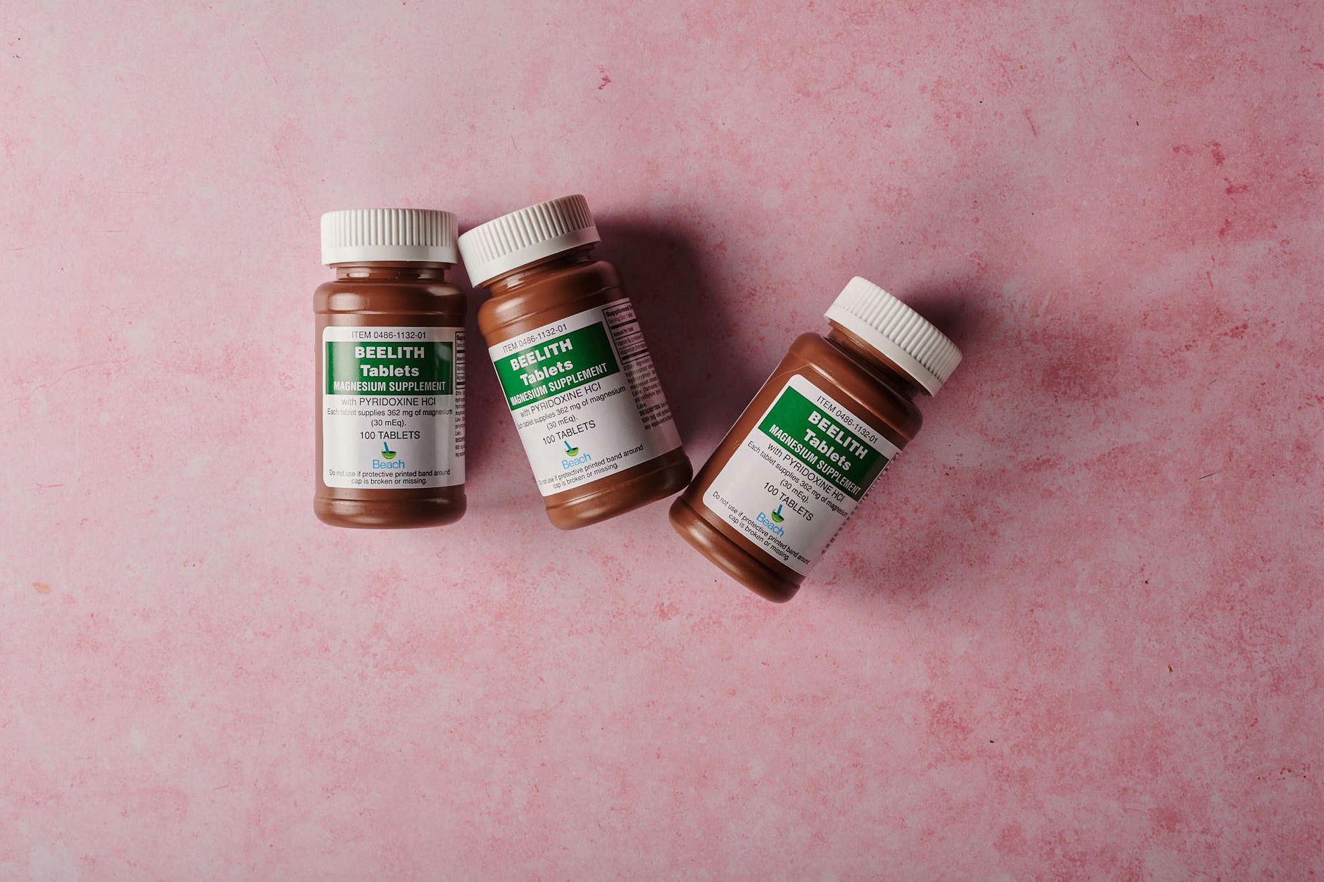 A collection of magnesium supplement bottles on a gym counter.
