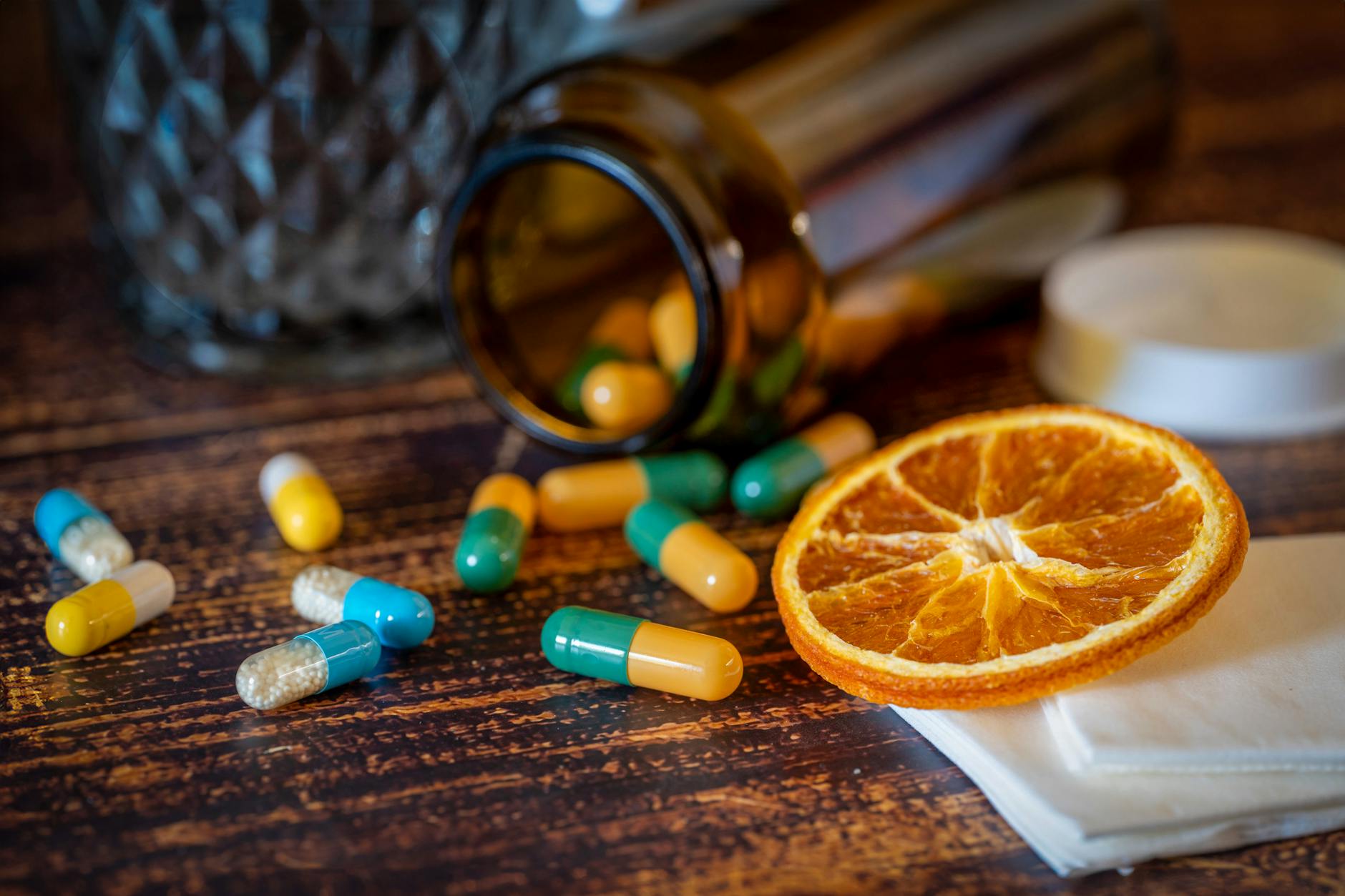 Bottle of zinc supplement pills on a gym bench with weights
