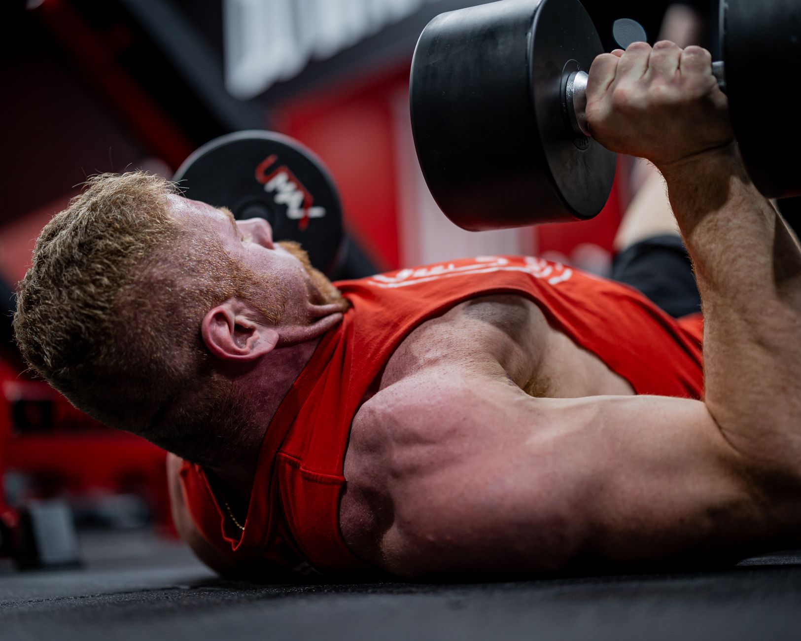 A determined lifter performing a heavy deadlift with a weightlifting belt.