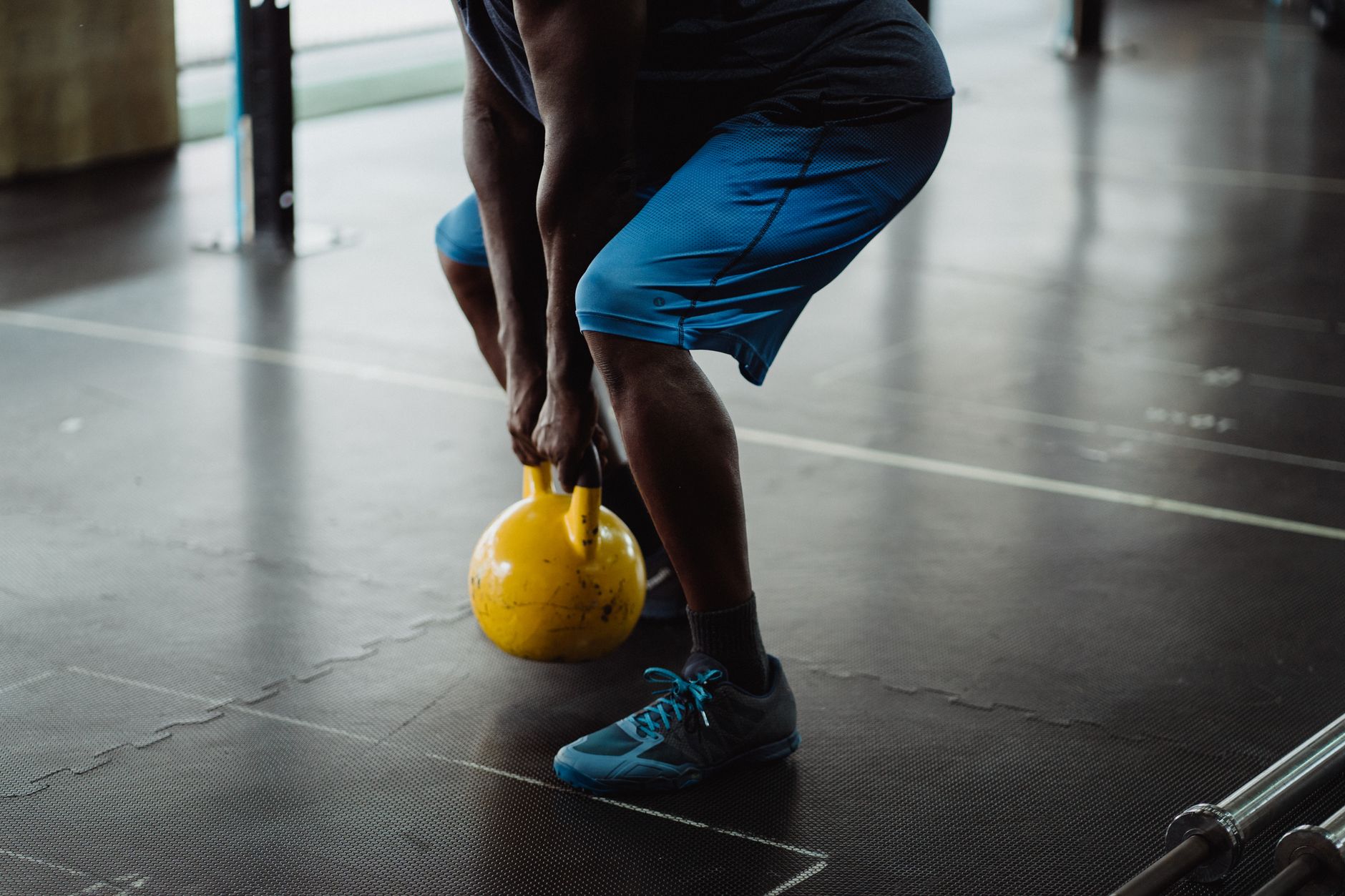 Lifter performing a deep barbell back squat, focused on achieving parallel depth.