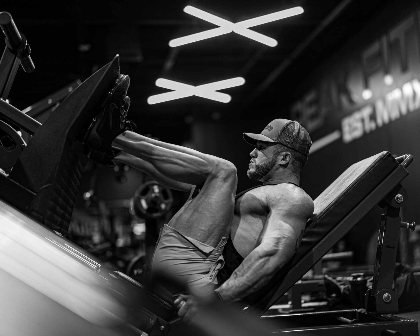 Man performing a heavy barbell bench press with intense focus.