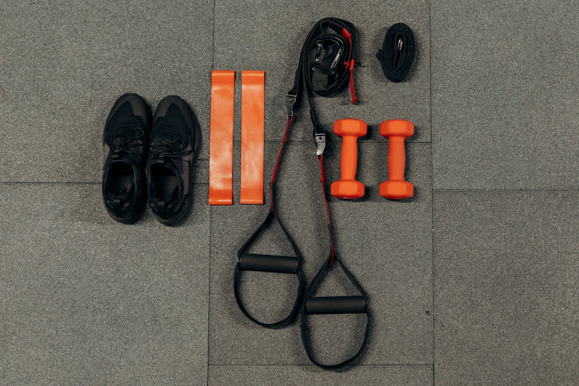 A person performing a resistance band exercise with intense focus.