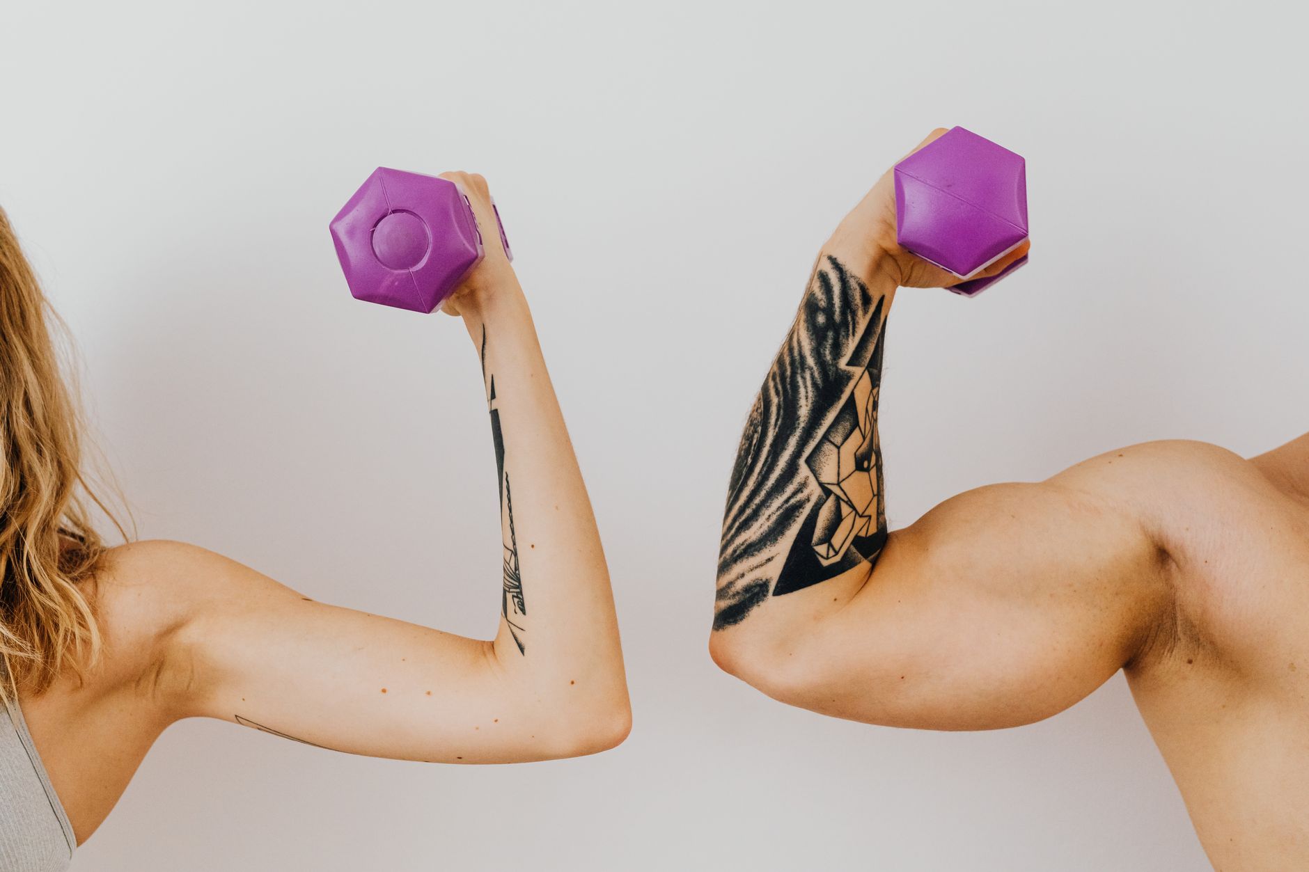 Man flexing biceps in a gym